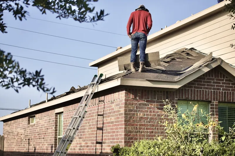 Professional roofer working on a residential roof in South Vienna